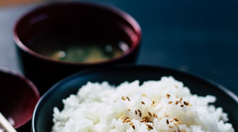 rice with sesame in black bowl